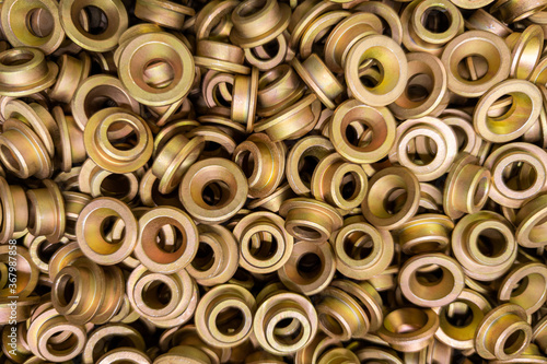 An abstract backround of yellow cadmium coated steel rings. Closeup with selective focus. photo