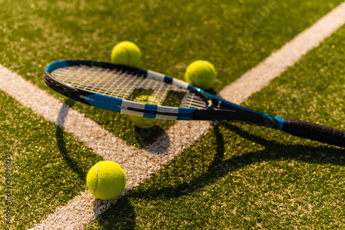 Tennis Racket on empty tennis grass court