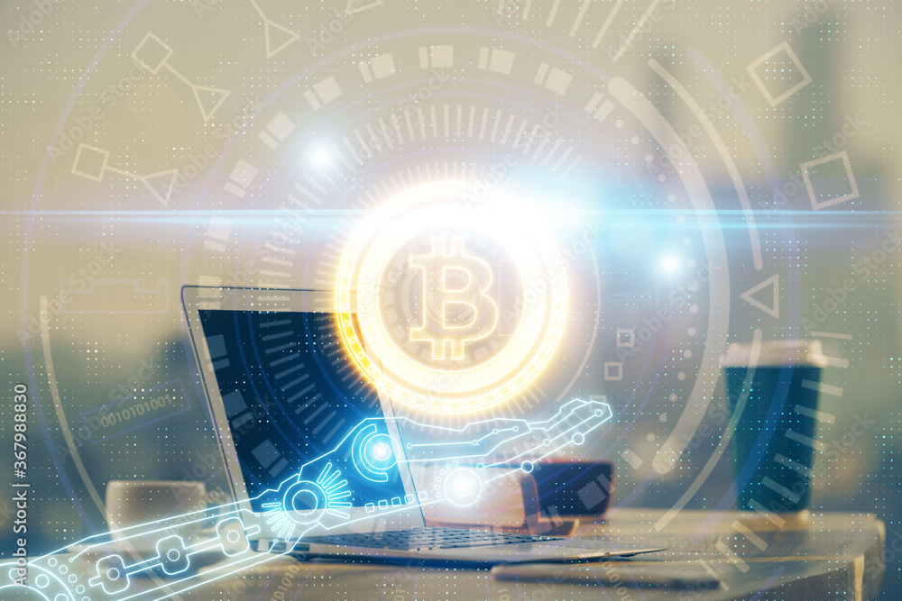 Multi exposure of blockchain theme hologram and table with computer background. Concept of bitcoin crypto currency.