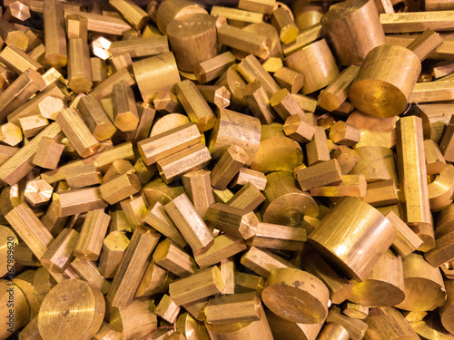 a pile of industrial scrap - brass turning leftovers and cutt off waste - waiting for recycle. photo