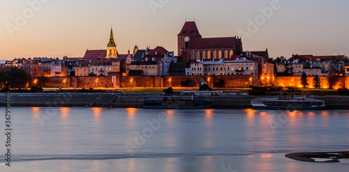 Sightseeing of Poland. Cityscape of Torun old town and Vistula river at night. UNESCO world heritage in Poland
