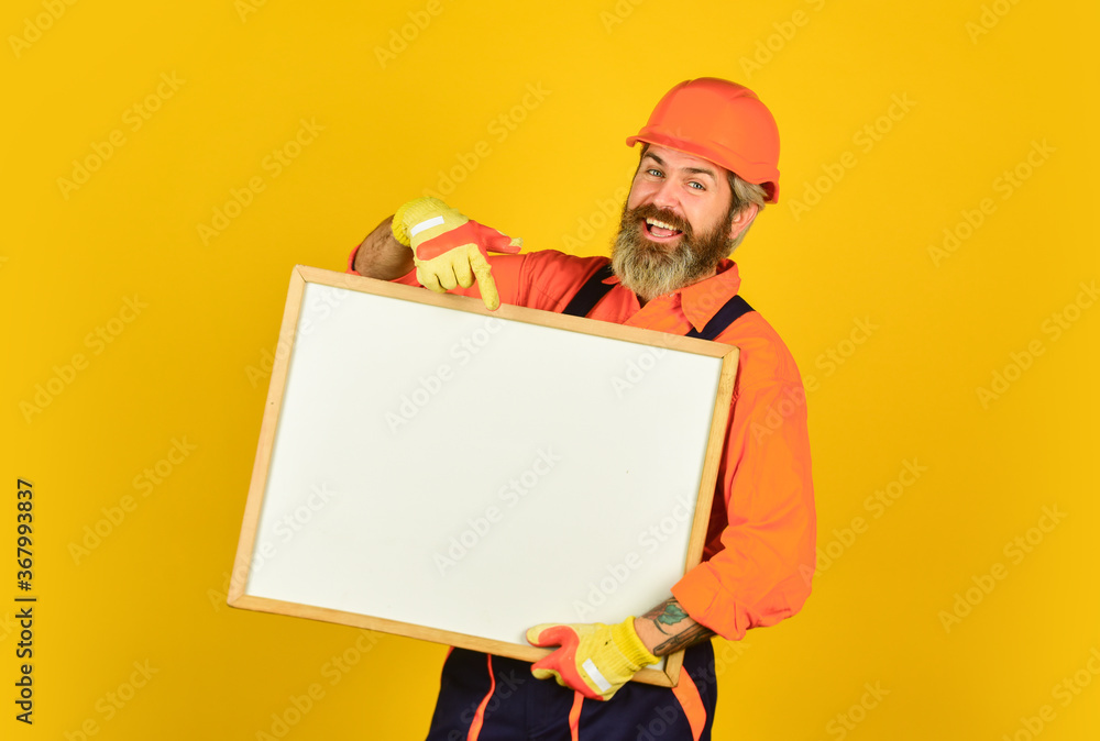 happy man with presentation. Builder points to flipchart. Architect worker hold flip chart. presenting flip-chart at meeting. male construction worker. copy space. planning new project happy man with presentation. Builder points to flipchart. Architect worker hold flip chart. presenting flip-chart at meeting. male construction worker. copy space. planning new project