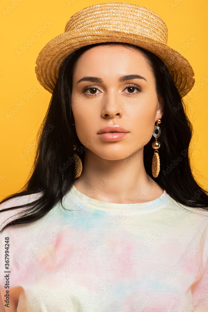 brunette girl in straw hat isolated on yellow brunette girl in straw hat isolated on yellow