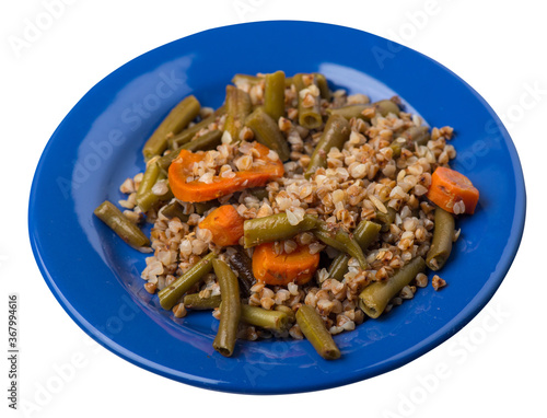 buckwheat with green beans with garlicand carrots isolated on white background. Diet breakfast on a green plate. healthy food vegetarian photo