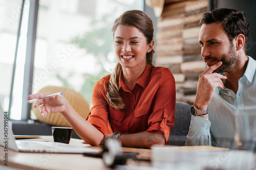 Wallpaper Mural Colleagues in office. Businesswoman and businessman discussing work in office. Two friends in working together.. Torontodigital.ca