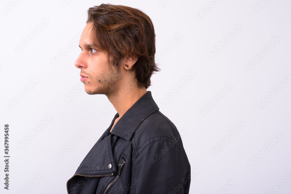 Young handsome rebellious man against white background Young handsome rebellious man against white background
