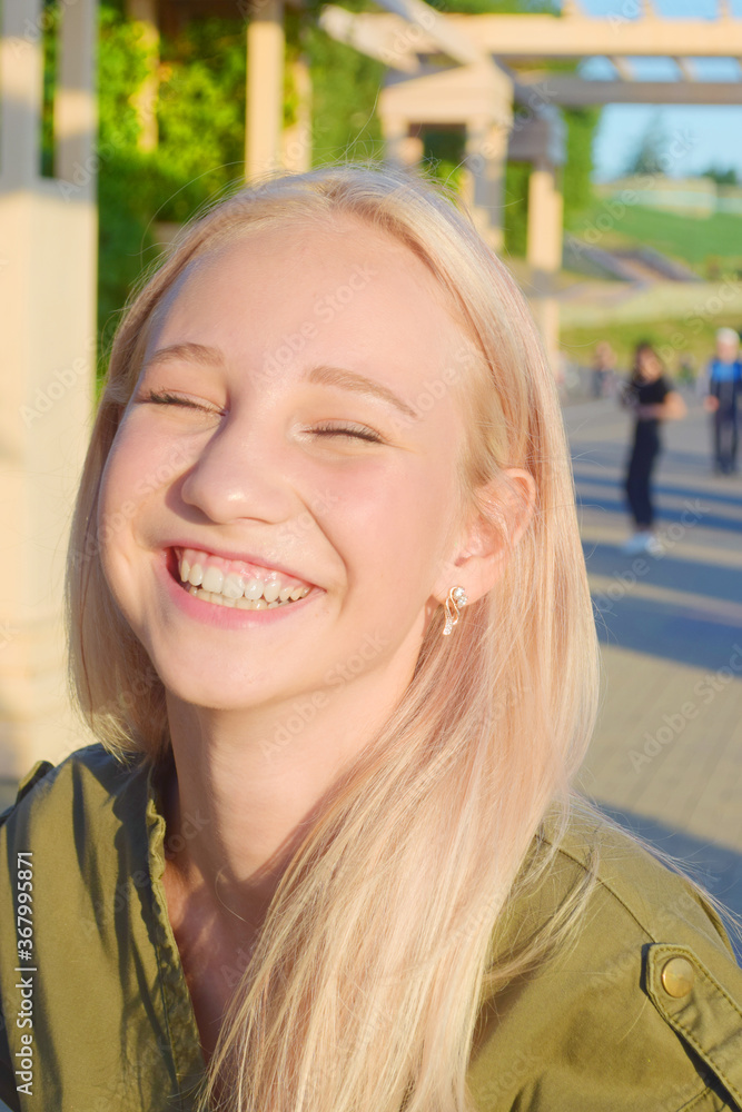 urban portrait of teenage girl having fun and laughing in park urban portrait of teenage girl having fun and laughing in park