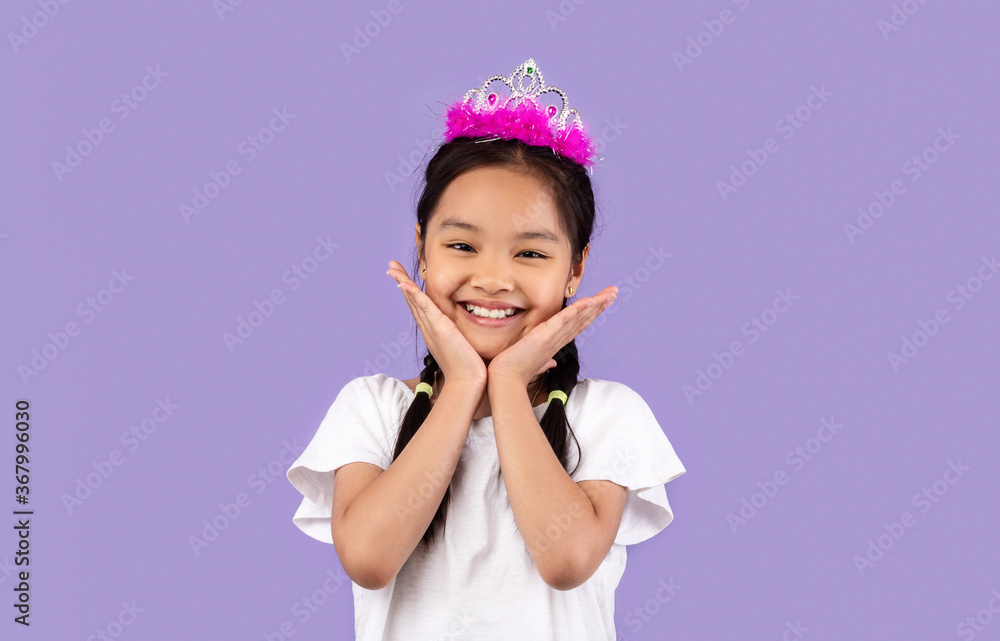 Cute Asian Girl Wearing Crown Posing On Purple Background Cute Asian Girl Wearing Crown Posing On Purple Background