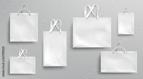 Paper shopping bags mockup, white packages with rope and lace handles, blank rectangular ecological gift packs, isolated mock up for branding and corporate identity design, Realistic 3d vector set