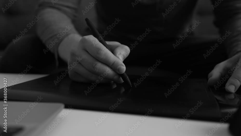 Graphic designer using electronic drawing tablet at home. Graphic designer using electronic drawing tablet at home.