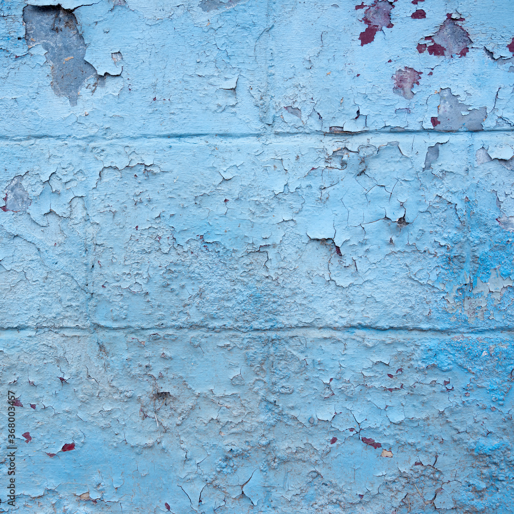 Fototapeta premium grungy blue painted cracked part of outside wall
