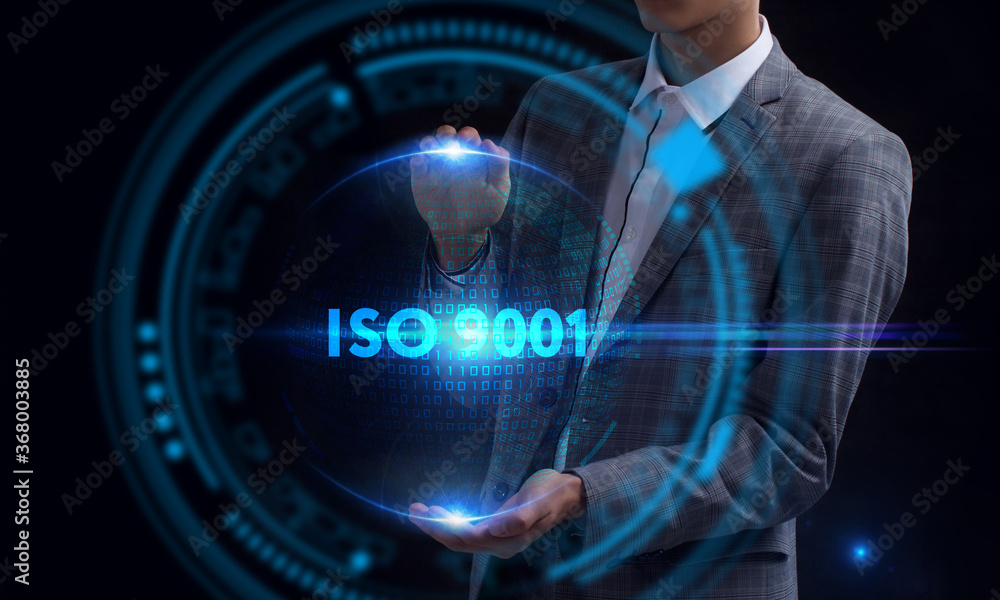 Business, Technology, Internet and network concept. Young businessman working on a virtual screen of the future and sees the inscription: ISO 9001