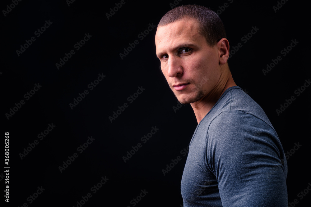 Naklejka premium Face of man with short hair against black background