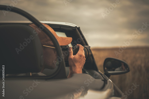 Tourist Taking Pictures From His Convertible Car While on the Road Trip