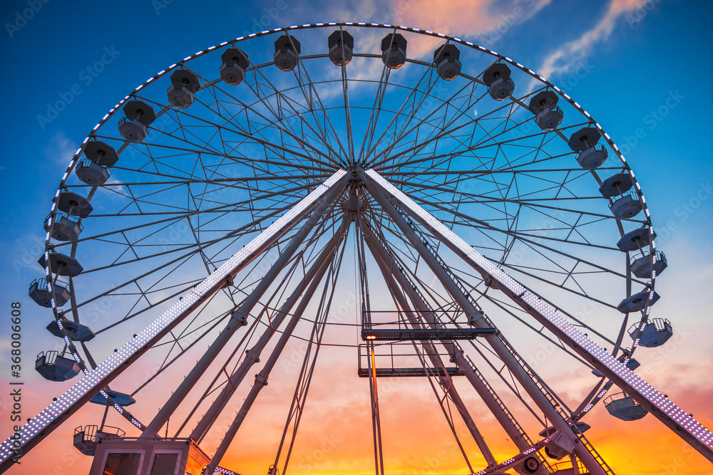 Ferris Wheel with sunset sky and clouds