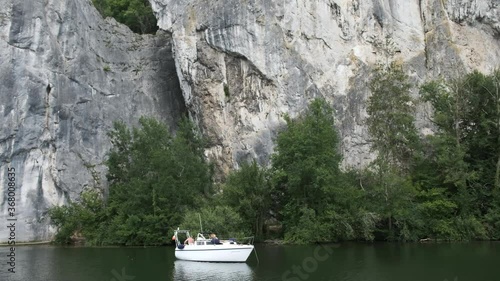 Small Boat Moored Next to a Big Cliff, Rock Formation in the River Meuse, Belgium