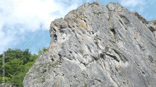 Rock Climber Making His Way Up a Cliff during Sunny Summer Day