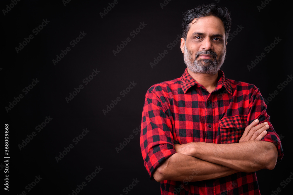 Naklejka premium Portrait of mature bearded Indian hipster man