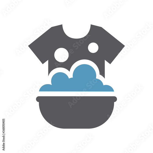 Clothes hand washing in a sink icon. T shirt in soap foam and bubbles in a basin simple vector laundry symbol.