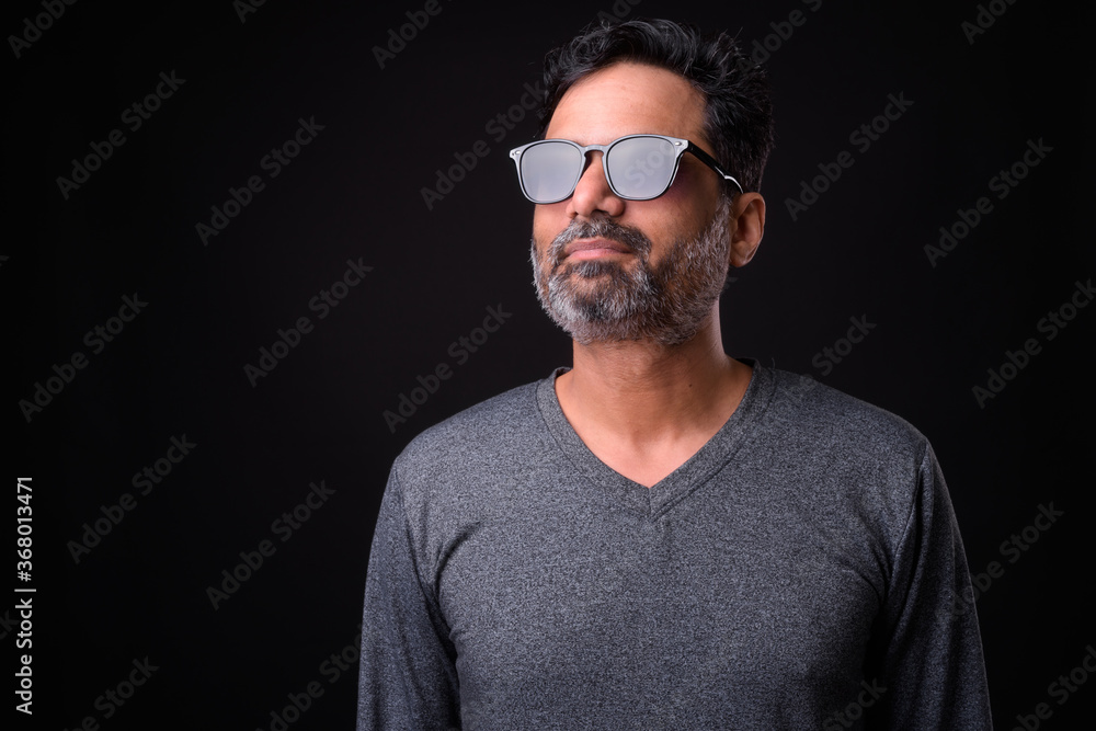 Portrait of mature bearded Indian man with curly hair