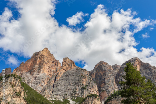 The peaks of the Italian Alps in the war of the purest blue sky with snow-white clouds