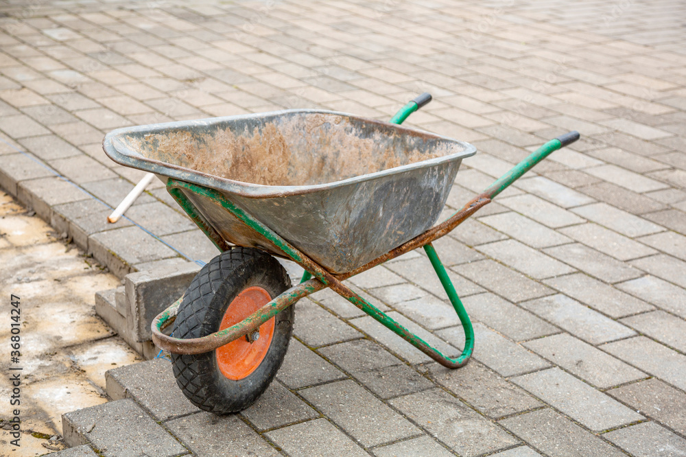 Iron trolley for manual moving of building materials in the garden and in the backyard Iron trolley for manual moving of building materials in the garden and in the backyard