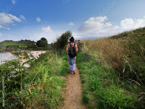 Hiking through the meadow near the seashore, on the beach. Summer on the north coast of Spain. Green landscapes © Jose Prieto