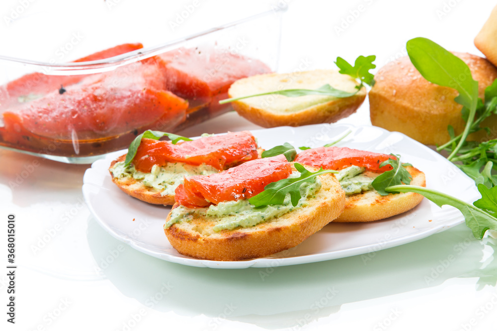 sandwich with fried bun, cheese spread and red fish in a plate sandwich with fried bun, cheese spread and red fish in a plate