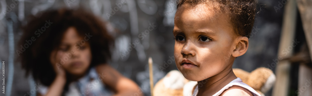 website header of poor african american child near curly sister website header of poor african american child near curly sister