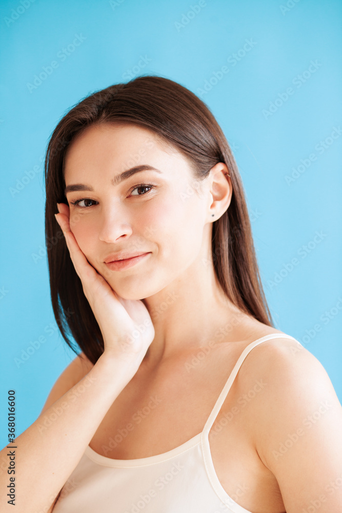 Lovely young woman with healthy skin against blue background Lovely young woman with healthy skin against blue background