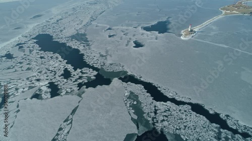 High altitude winter Tokarevsky lighthouse Vladivostok Russia from great height. Cinematic Amur Bay, Eastern Bosphorus frozen sea ice texture. Navigation sailing. City best travel landmark. Far East photo