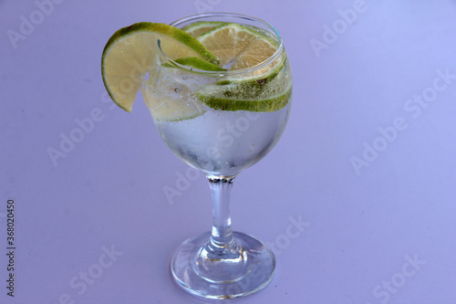 mineral water and lemon in a glass cup