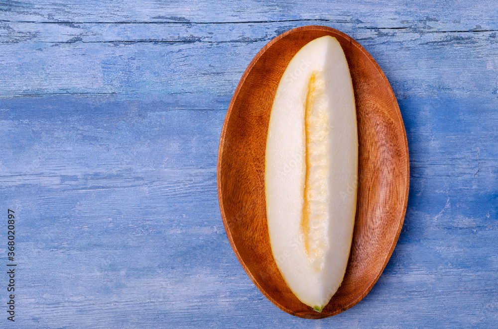 Slices of raw melon on an old blue wooden background. Slices of raw melon on an old blue wooden background.