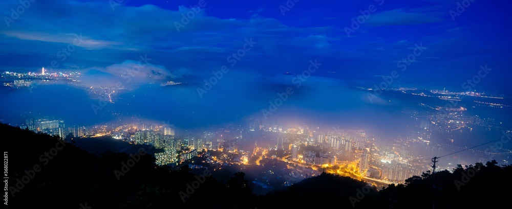 Panoramic shot of cityscape at night - obrazy, fototapety, plakaty 