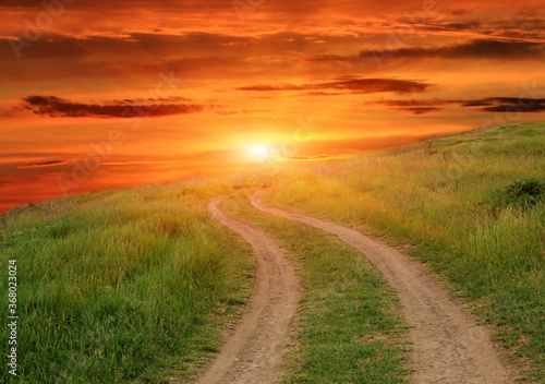 dirt road on sunset background
