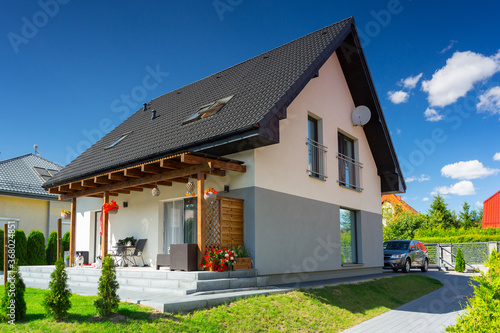 A modern single family house with a garden in summer scenery