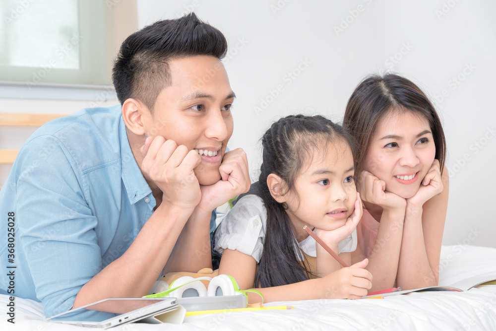 Asian family happy smiling and relax on bed at home in holiday vacation. Photo series of family, kids and happy people concept. Asian family happy smiling and relax on bed at home in holiday vacation. Photo series of family, kids and happy people concept.