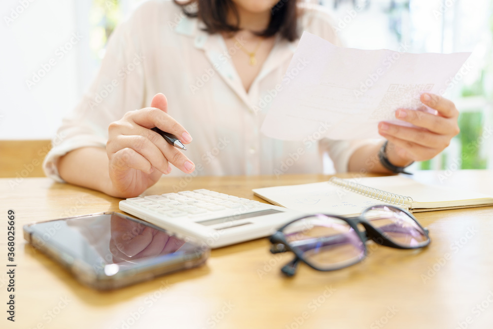 owner Sitting on the annual tax calculation Bracelets from turnover To reduce the tax. using as background business concept and finance concept with copy space for your text or design. owner Sitting on the annual tax calculation Bracelets from turnover To reduce the tax. using as background business concept and finance concept with copy space for your text or design.