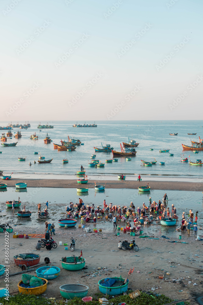 MUI NE / VIETNAM - December 28, 2019 :  view on Fishing village and traditional fishing boat with hundreds boats anchored ( fishing harbour market)