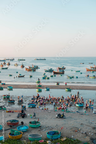 MUI NE / VIETNAM - December 28, 2019 : view on Fishing village and traditional fishing boat with hundreds boats anchored ( fishing harbour market)