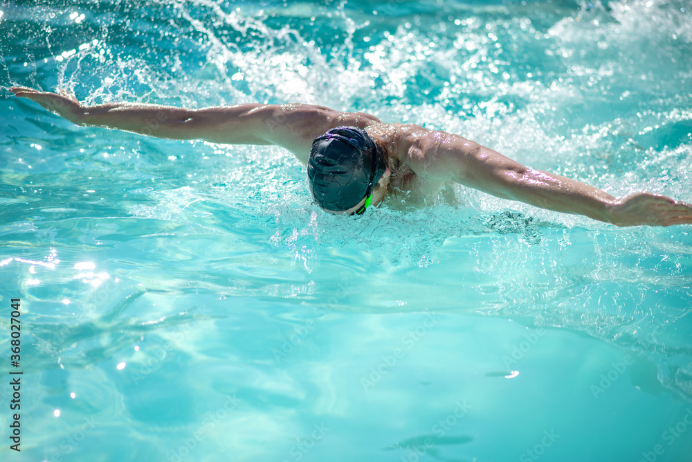 Professional male swimmer having a workout in pool Professional male swimmer having a workout in pool