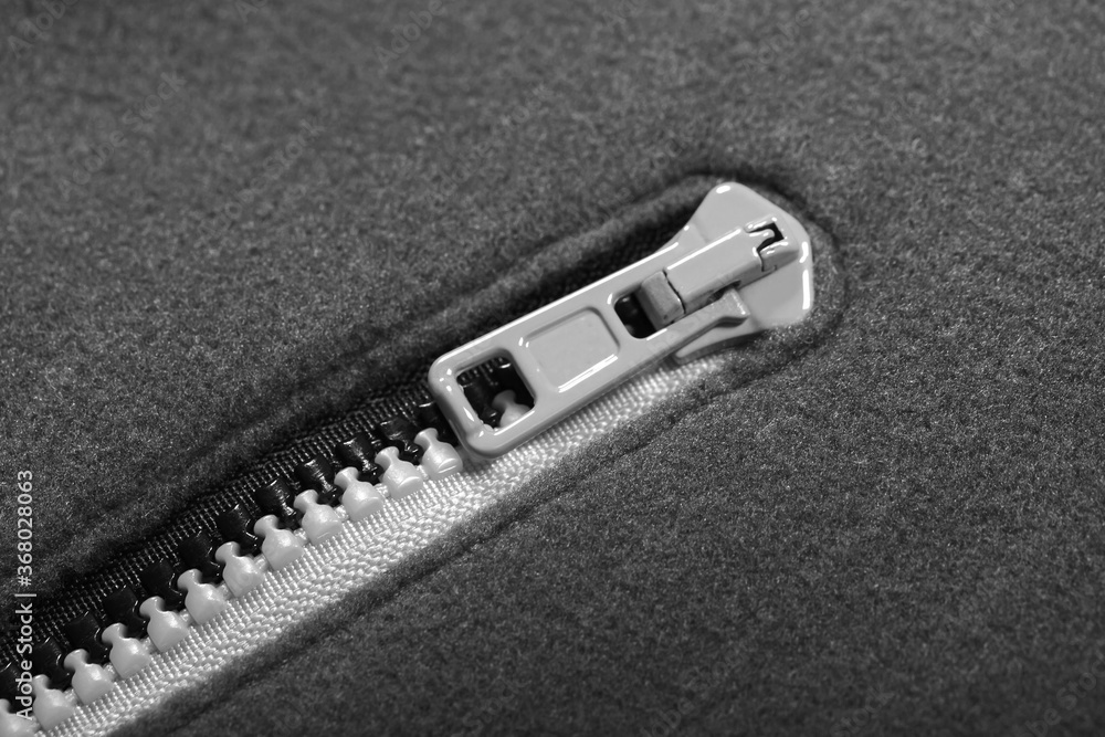 Zipper of a gray fleece jacket, close-up Zipper of a gray fleece jacket, close-up