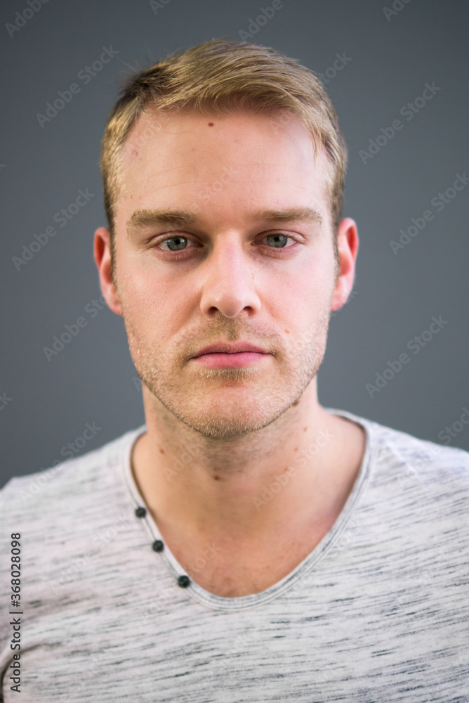 Fototapeta premium Portrait of young handsome man with blond hair