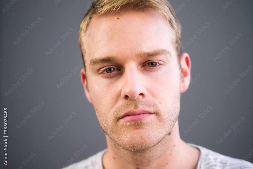 Fototapeta premium Portrait of young handsome man with blond hair