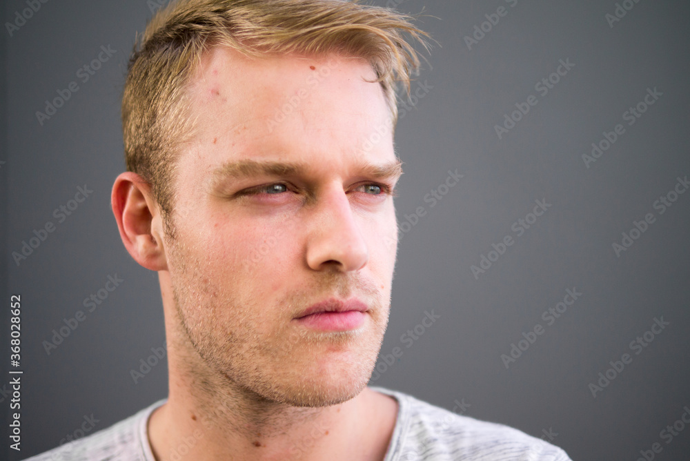 Obraz premium Portrait of young handsome man with blond hair