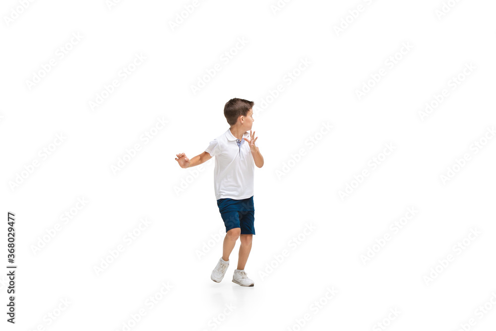 Happy kids, little and emotional caucasian boy jumping and running isolated on white background. Look happy, cheerful, sincere. Copyspace for ad. Childhood, education, happiness concept. Happy kids, little and emotional caucasian boy jumping and running isolated on white background. Look happy, cheerful, sincere. Copyspace for ad. Childhood, education, happiness concept.