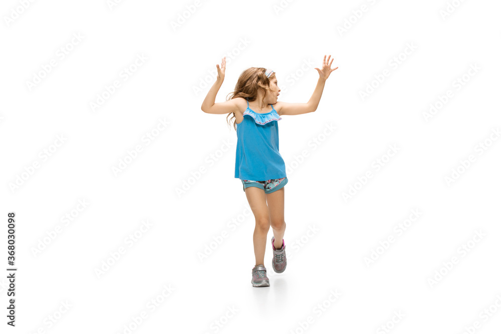Happy kids, little and emotional caucasian girl jumping and running isolated on white background. Look happy, cheerful, sincere. Copyspace for ad. Childhood, education, happiness concept. Happy kids, little and emotional caucasian girl jumping and running isolated on white background. Look happy, cheerful, sincere. Copyspace for ad. Childhood, education, happiness concept.