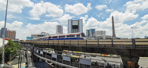 BTS sky train runs through the station. View of Bangkok skyline and skyscraper with BTS skytrain. 