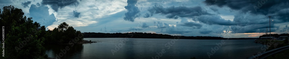 180 degrees panorama of a dramatic sky close to Barren River Lake State Park Marina during sunset.
