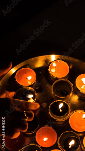 A candle is an ignitable wick embedded in wax, or another flammable solid substance such as tallow, that provides light, and in some cases, a fragrance.  photo